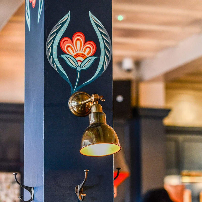 Baku Brass Wall Light with adjustable arm and aged metal finish for vintage industrial home lighting
