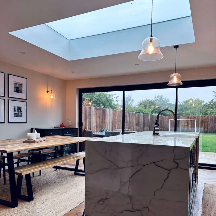 Modern kitchen with marble island and large window