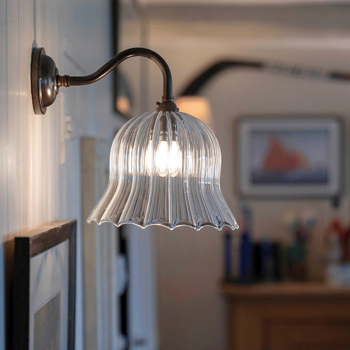 Bodium Medium Ribbed Glass Wall Light with flared shade illuminating a cozy interior space