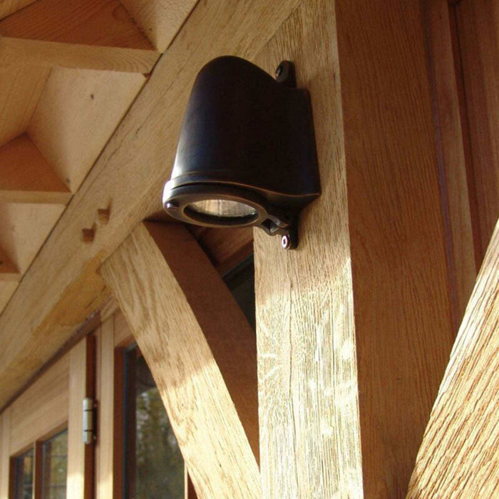 Bourne Outdoor Mast Light in bronze finish illuminating garden pathway at night
