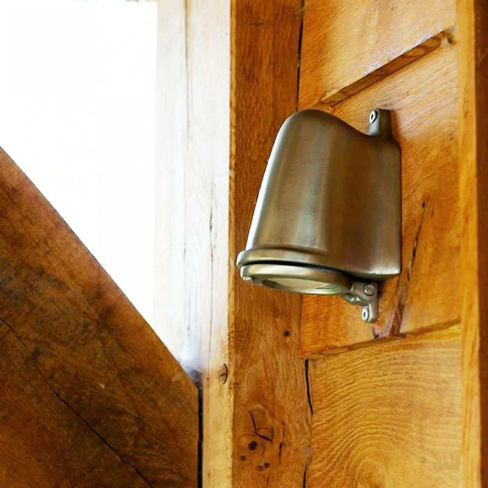 Bourne Outdoor Mast Light installed on exterior wall illuminating pathway in classic bronze finish