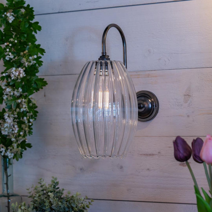 Camber Large Ribbed Glass Shade Wall Light with ribbed glass and swan neck arm in antique brass finish