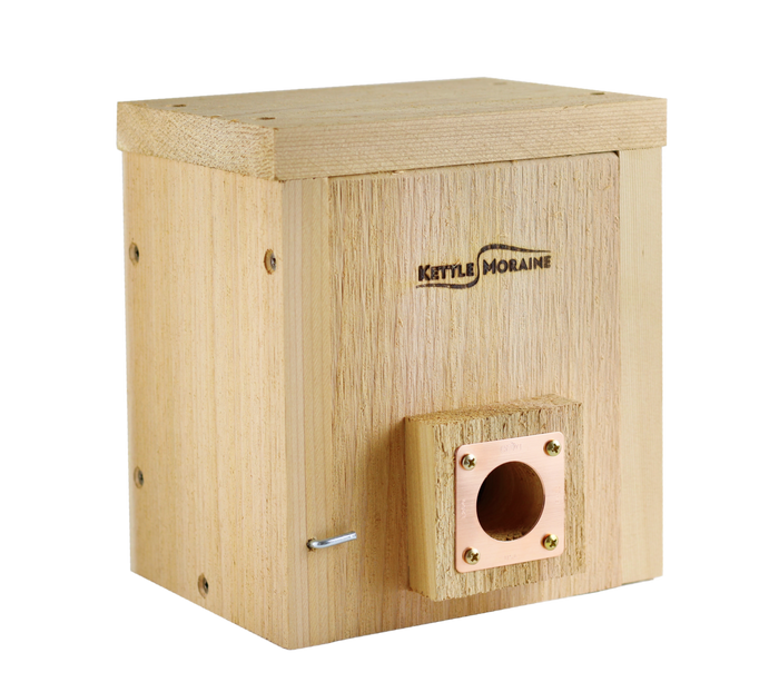 Small cedar roosting box with a copper portal and cedar predator guard around the entrance hole.