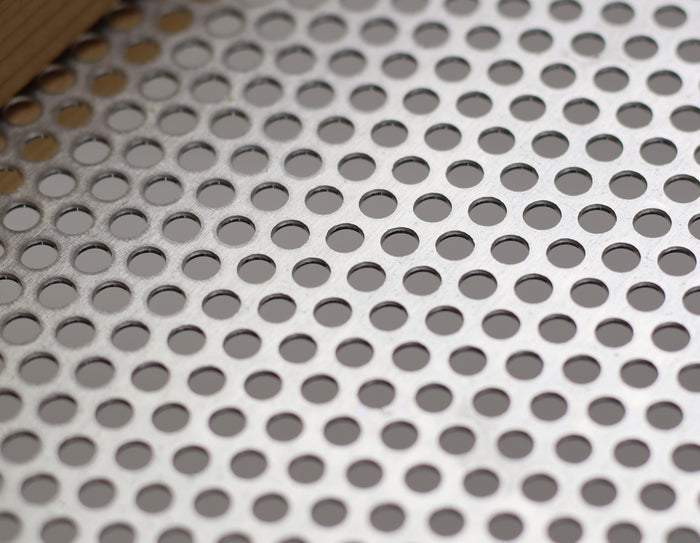 Perforated metal bottom used in cedar tray feeders to drain rain water and preserve bird seed.