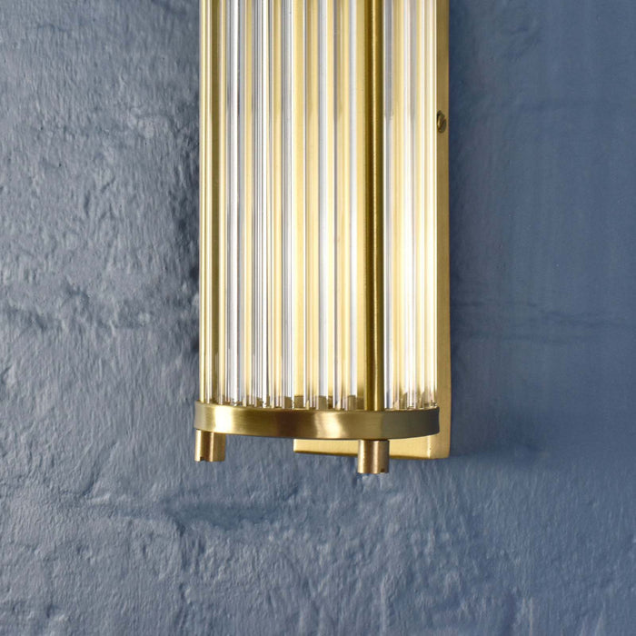 Chester Glass Rodded Bathroom Wall Light in satin brass with IP44 moisture resistance above mirror