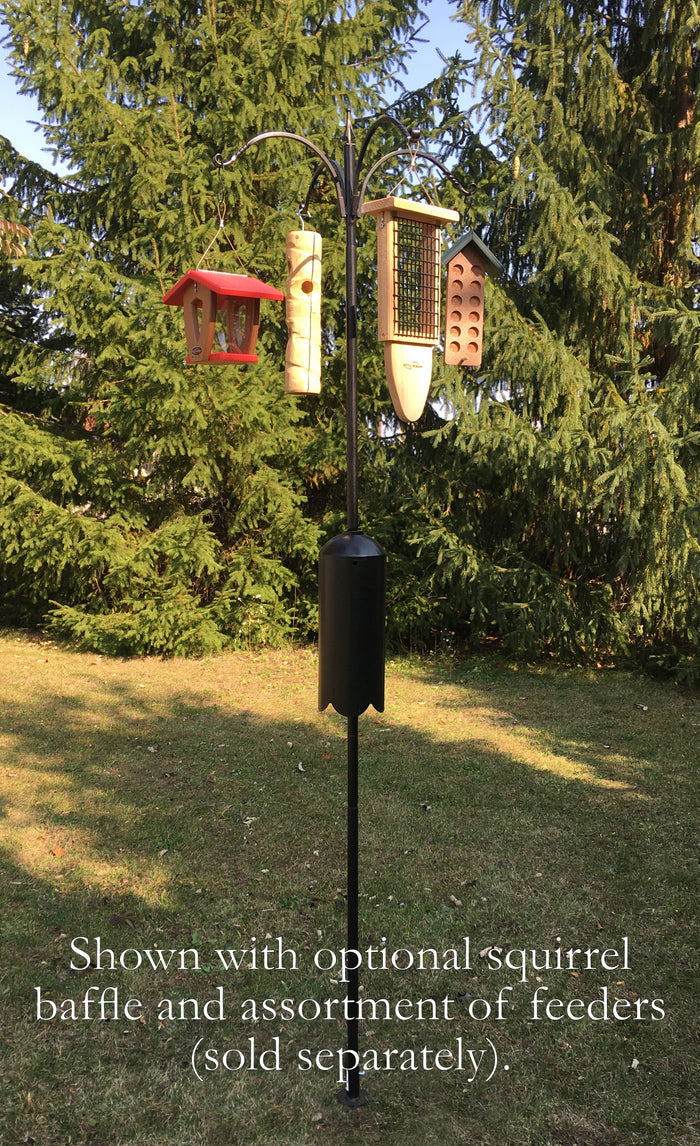 Black pole with a squirrel baffle and a four arm topper holds an arrangement of bird feeders (sold separately)