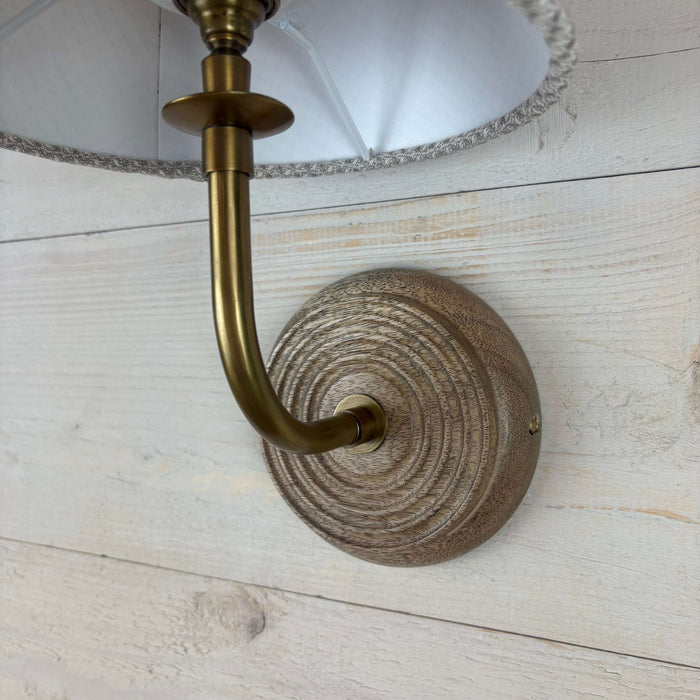 textured waffle empire shade, handmade in the uk 20cm. On a mango wood wall light ficxture with a brass arm