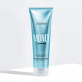 Blue shampoo bottle labeled 'Color Wow Money Laundering Glossing Conditioner' on a white background