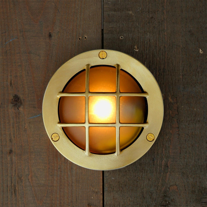 Muara Bulkhead IP64 outdoor wall light with circular design and protective grille for durable exterior lighting