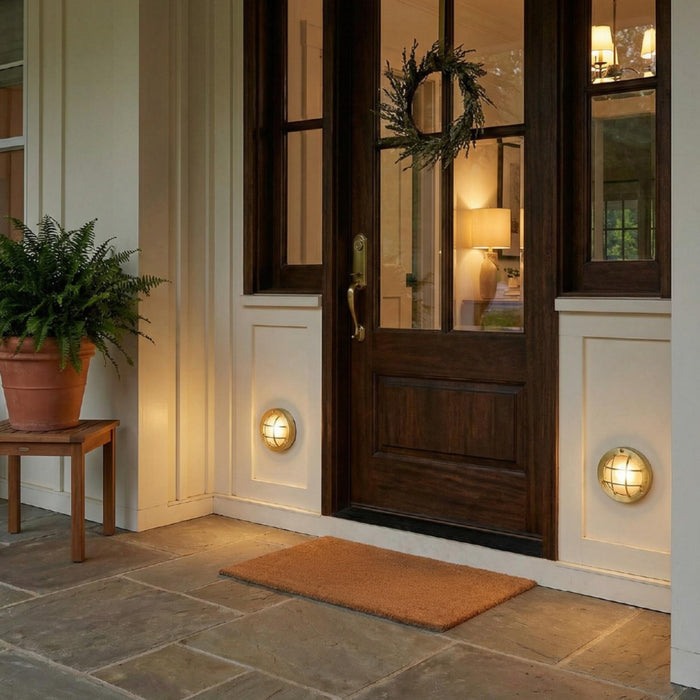 Muara Bulkhead IP64 outdoor wall light with protective grille and industrial design, ideal for patios and garden walls