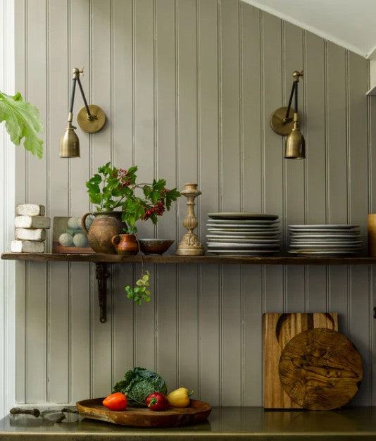 Pooky Pick Brass Wall Light with adjustable arm and warm brass finish mounted on wall