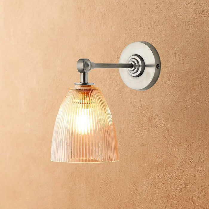 Tiny Qilin Bathroom Wall Light with prismatic glass shade and antique brass finish mounted on bathroom wall