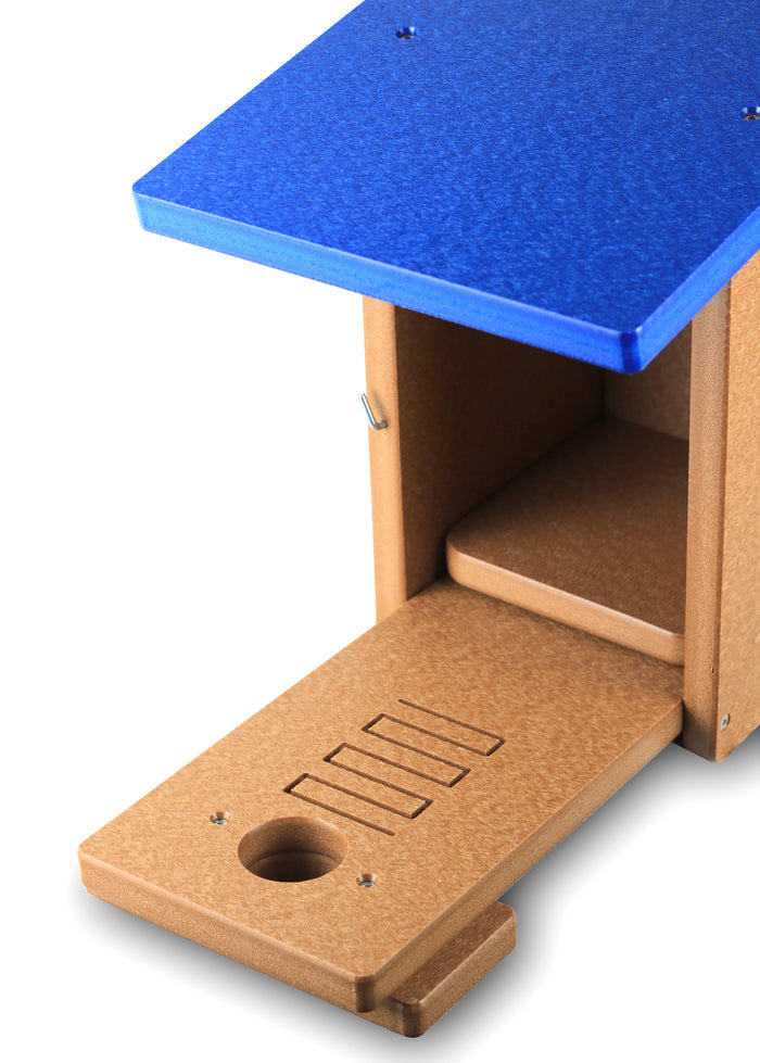 Brown bird house with blue roof has front panel open showing fledgling ladder.