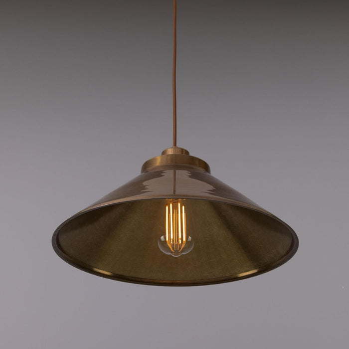 Rio Vintage Modern Brass Pendant Light with conical shade hanging indoors, showcasing vintage and modern design elements.