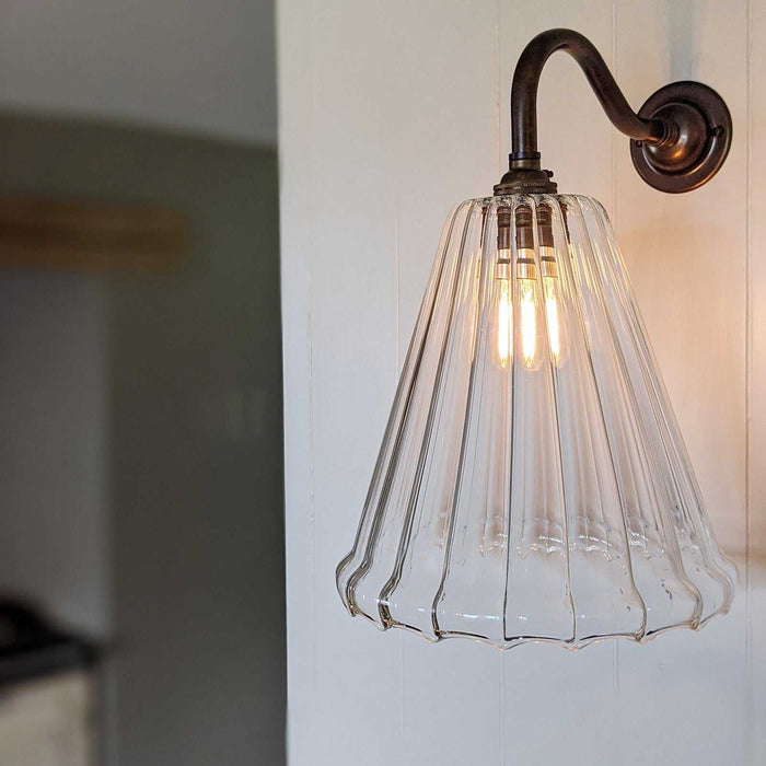 Rye Medium Ribbed Glass wall light with elegant ribbed glass shade creating warm ambient lighting