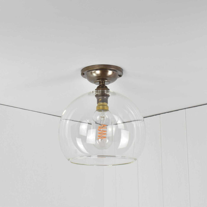 Soho Medium Clear Glass globe flush ceiling light with minimalist design and handblown glass shade