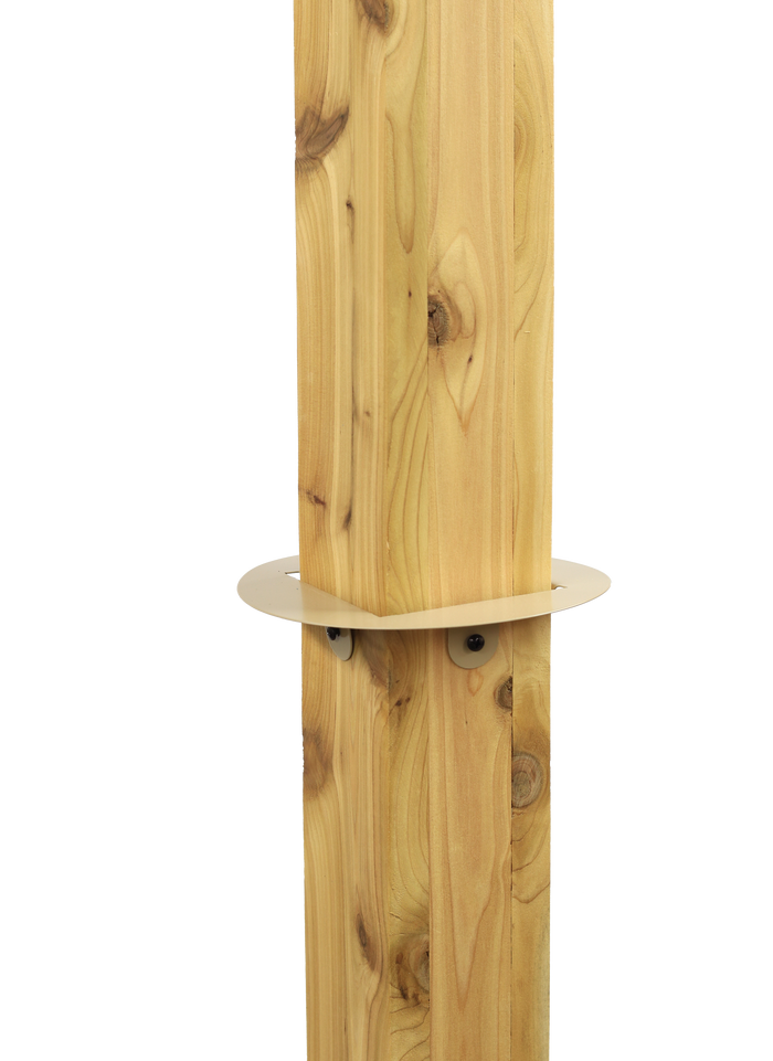 Circular metal piece with a square cut out is attached to a square wooden post using screws. Used with a squirrel baffle.