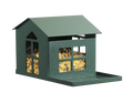A green metal squirrel house feeder filled with seed features a lifting roof and a large 'porch' on the front, designed to hang on a tree or post.
