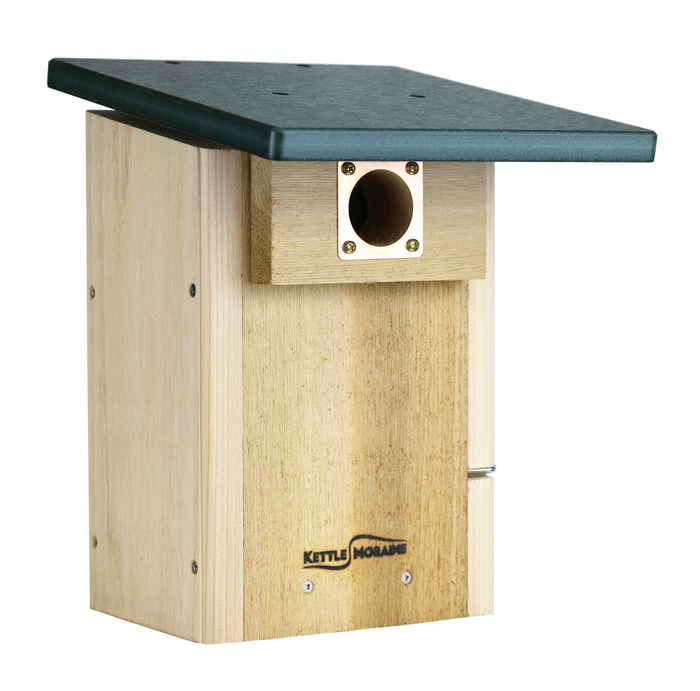 A super blue bird house made of cedar with a green recycled plastic roof and a copper portal framing the entrance