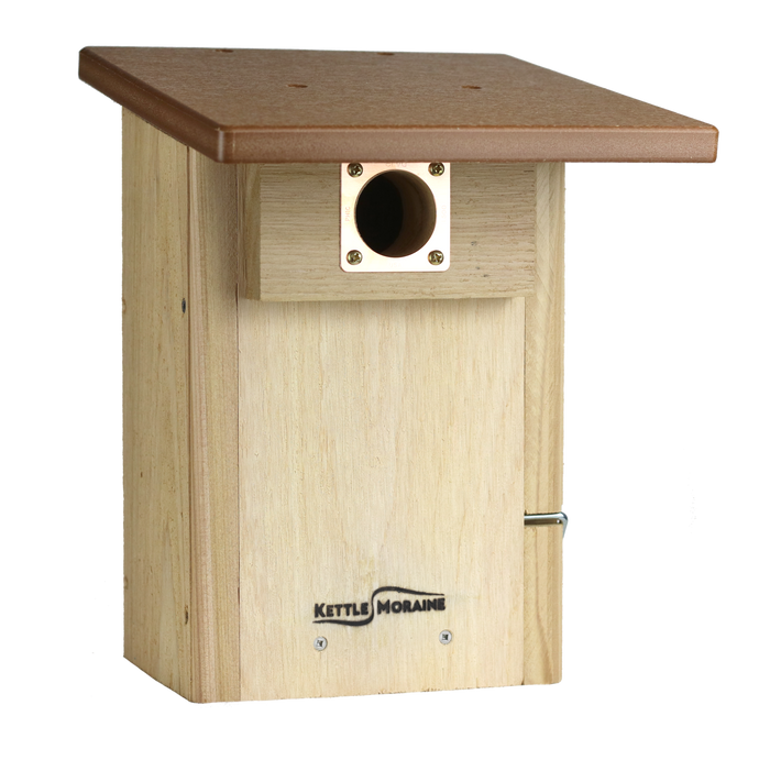 Cedar bird house with a brown recycled plastic roof and a copper portal framing the entrance hole. Side panel hinges open to a clear viewing window