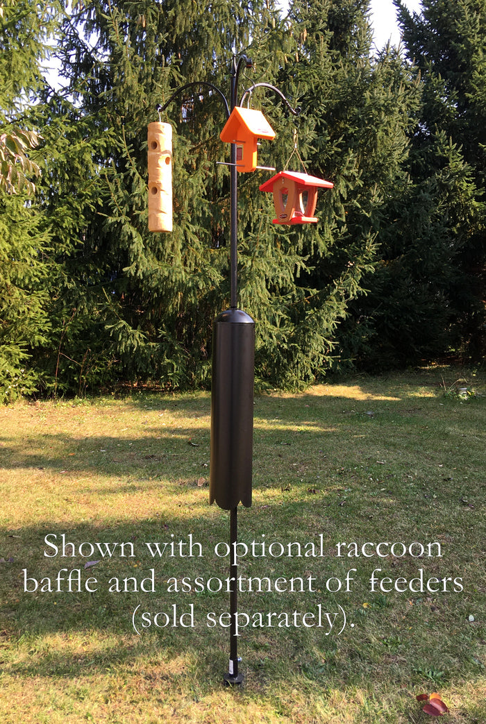 Three arm pole kit with an assortment of bird feeders sold separately. Shown with a racoon baffle in a yard with pine trees.