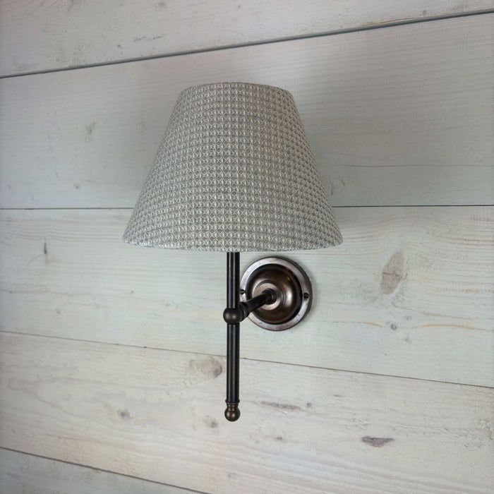 textured waffle empire shade, handmade in the uk 20cm. On an antique brass straight arm lupin fitting handcrafted in the UK.