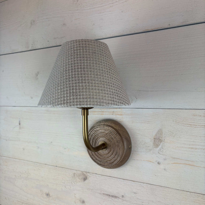 textured waffle empire shade, handmade in the uk 20cm. On a mango wood wall light ficxture with a brass arm