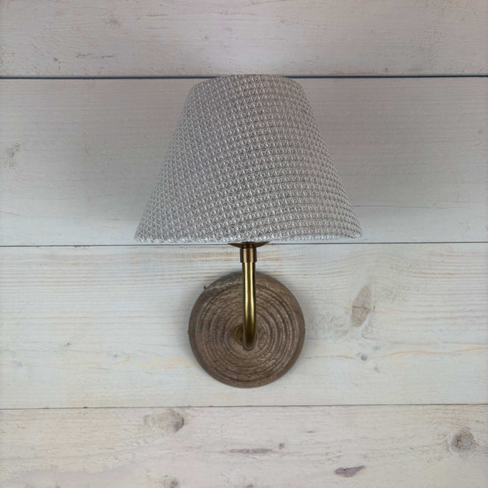 textured waffle empire shade, handmade in the uk 20cm. On a mango wood wall light ficxture with a brass arm