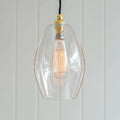 Wonky Camber Clear Glass Pendant Light medium fluted design with artisan imperfections and warm ambient glow
